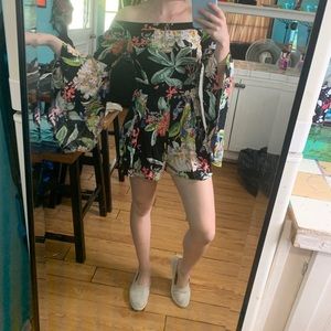 Cute black romper with a colorful floral pattern